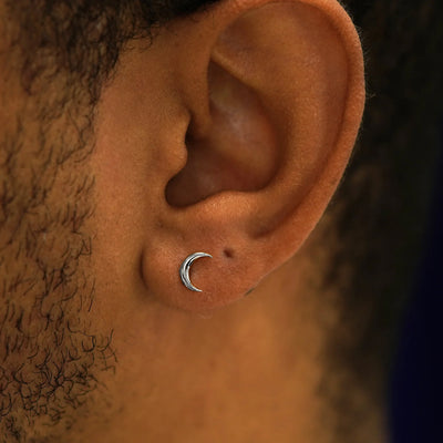 Close up view of a model's ear wearing a  14k white gold Moon Earring