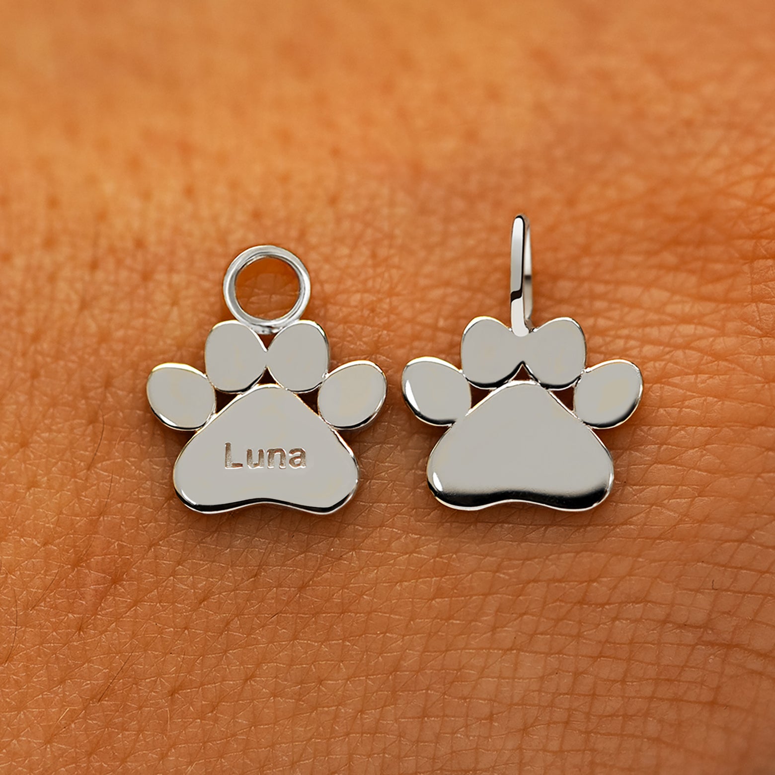 Two solid 14k white gold Paw Charms showing the for chain and the for earring options