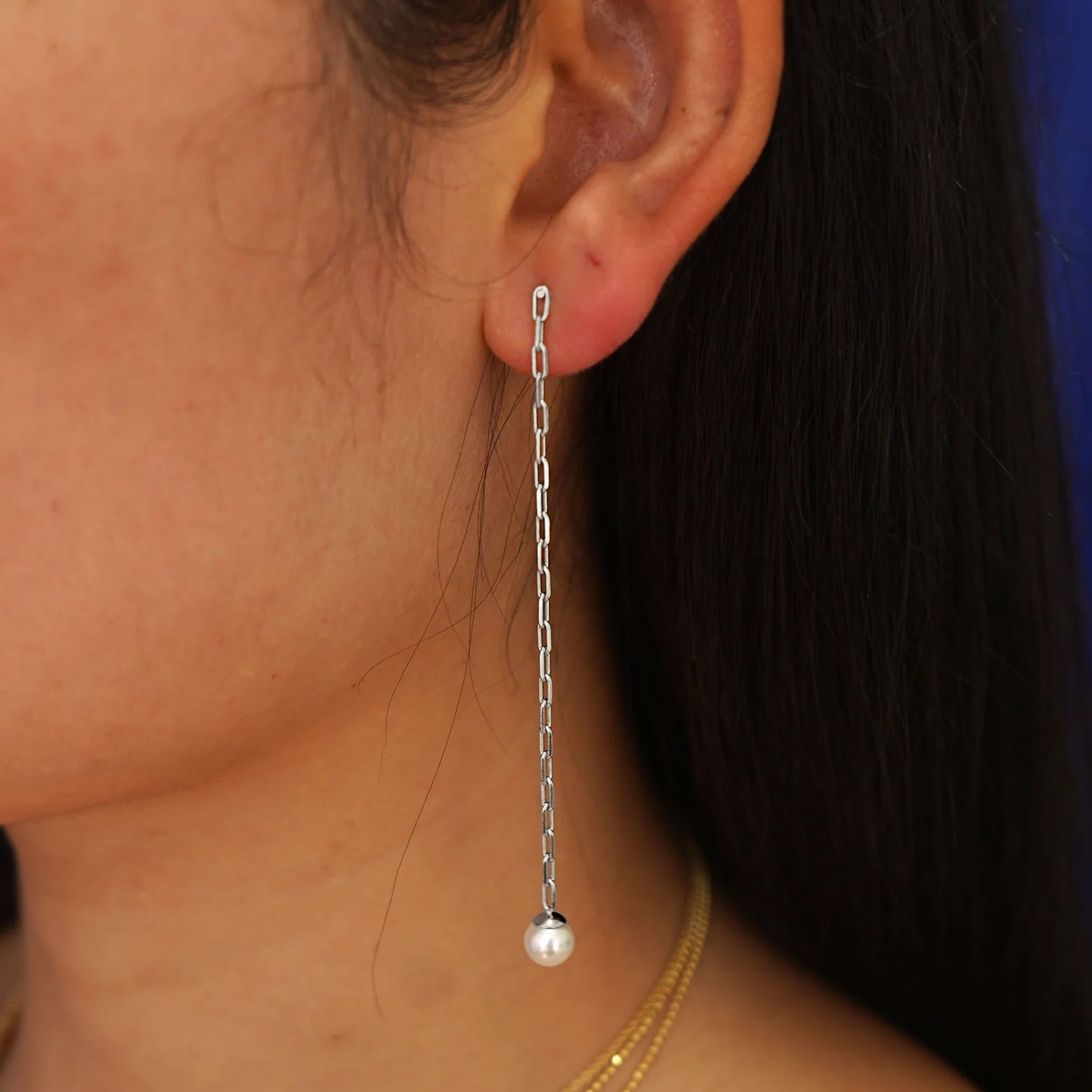 Close up view of a model's ear wearing a 14 karat white gold Pearl Dangle Earring