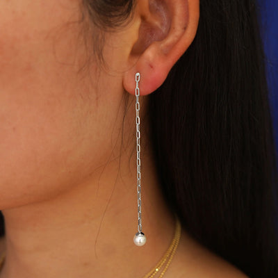 Close up view of a model's ear wearing a 14 karat white gold Pearl Dangle Earring