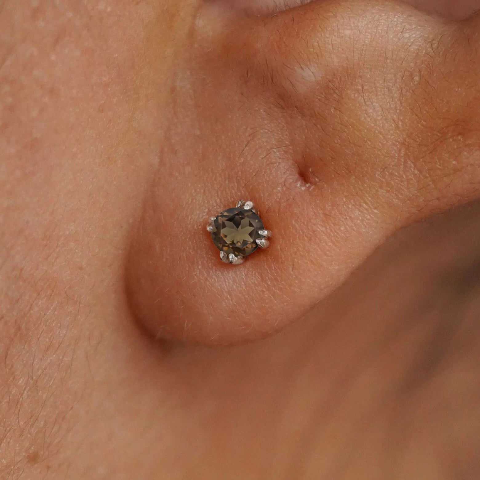 Close up view of a model's ear wearing a 14k white gold Rose Quartz Earring