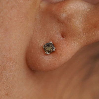 Close up view of a model's ear wearing a 14k white gold Rose Quartz Earring