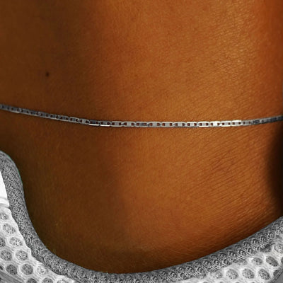 Close up view of a models ankle wearing a 14k white gold Valentine Anklet