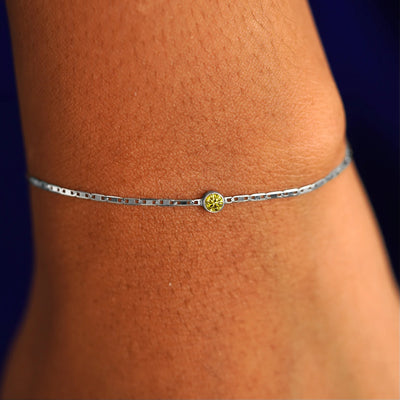 A model's wrist wearing a 14 karat white gold Yellow Diamond Bracelet