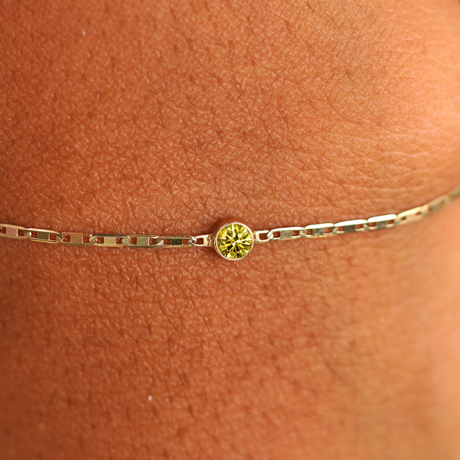 Close up view of a models wrist wearing 14k yellow gold Yellow Diamond Bracelet