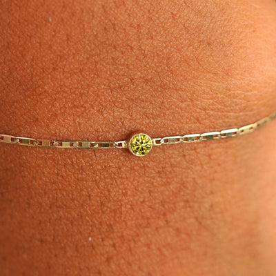 Close up view of a models wrist wearing 14k yellow gold Yellow Diamond Bracelet