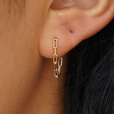 A model's ear wearing a yellow gold Butch Chain Loop Earring