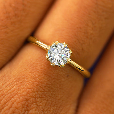 Close up view of a model's hand wearing a solid yellow gold Lab Diamond Petal Ring