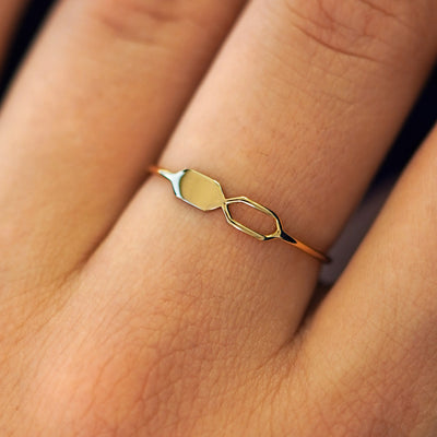 Close up view of a model's fingers wearing a 14k yellow gold Tanlah Ring
