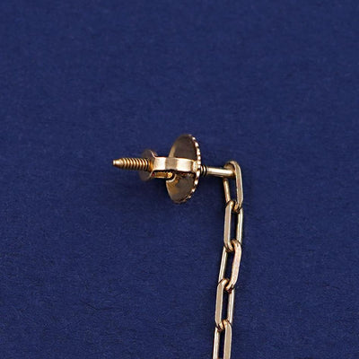 Close up view of solid gold screwback post with backing